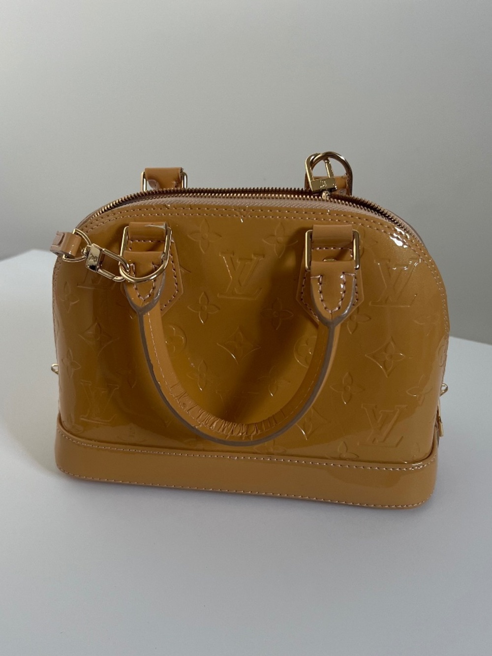 Glossy monogram top handle handbag